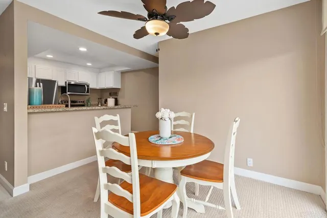 a kitchen with kitchen island granite countertop a refrigerator and a stove top oven