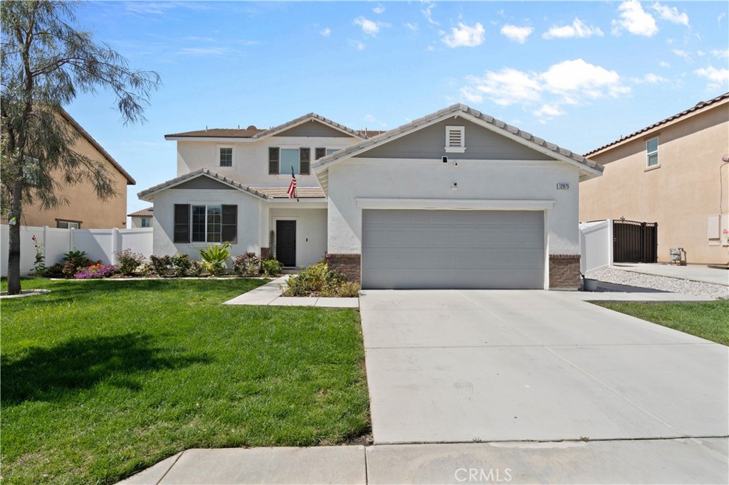 a front view of a house with a yard and garage