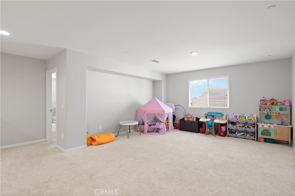 12875 Wainwright Lane Moreno Valley, CA 92555 - Photo 17 of 37 a playing room with furniture and a window