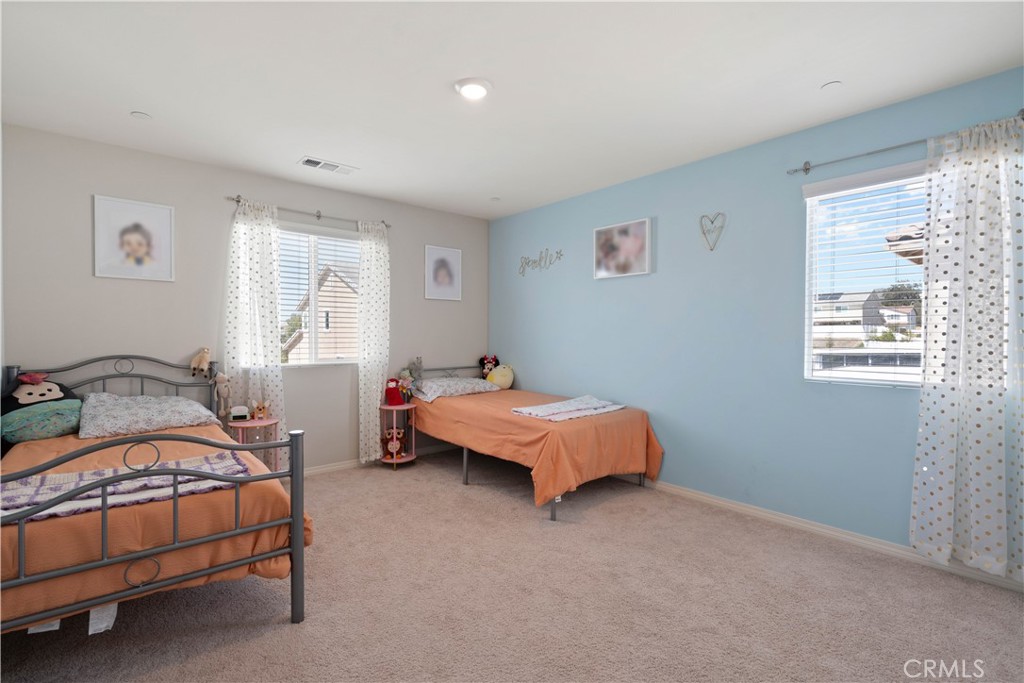 12875 Wainwright Lane Moreno Valley, CA 92555 - Photo 18 of 37 a bedroom with a bed and window