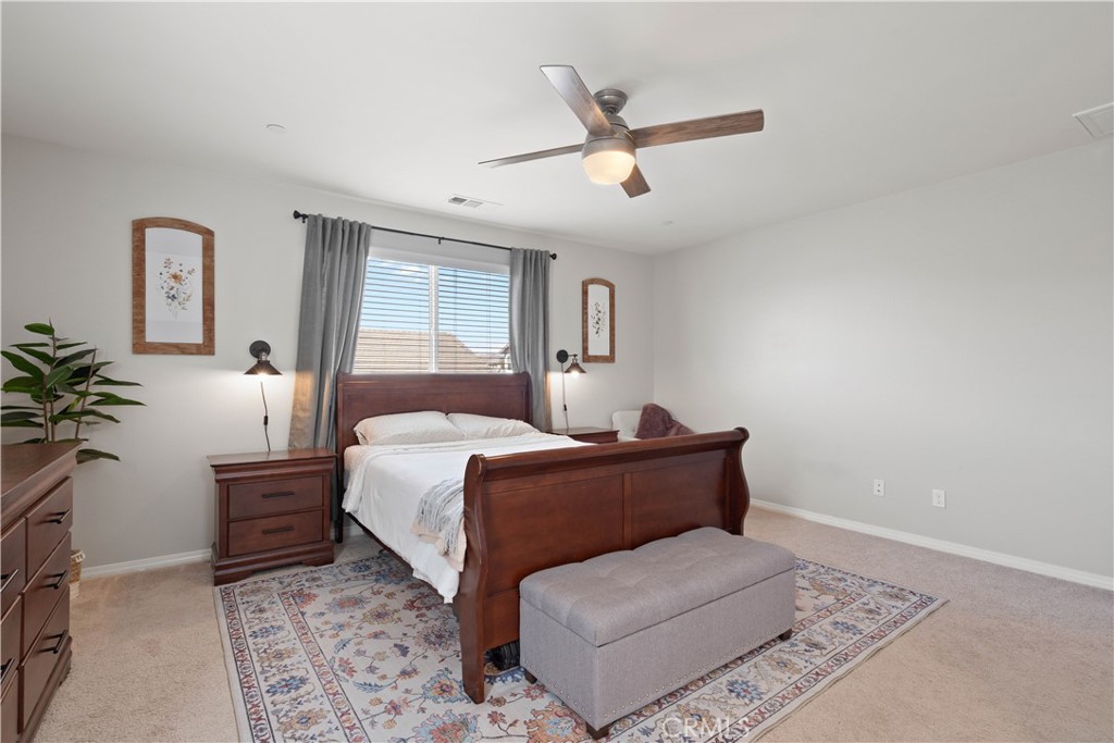 12875 Wainwright Lane Moreno Valley, CA 92555 - Photo 21 of 37 a bed room with a bed and a potted plant