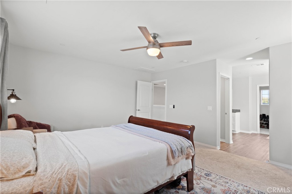 12875 Wainwright Lane Moreno Valley, CA 92555 - Photo 24 of 37 a bedroom with a bed and cabinets