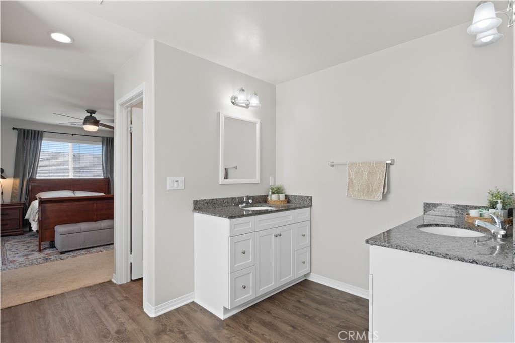 12875 Wainwright Lane Moreno Valley, CA 92555 - Photo 25 of 37 a en suite bathroom with a granite countertop sink and a mirror