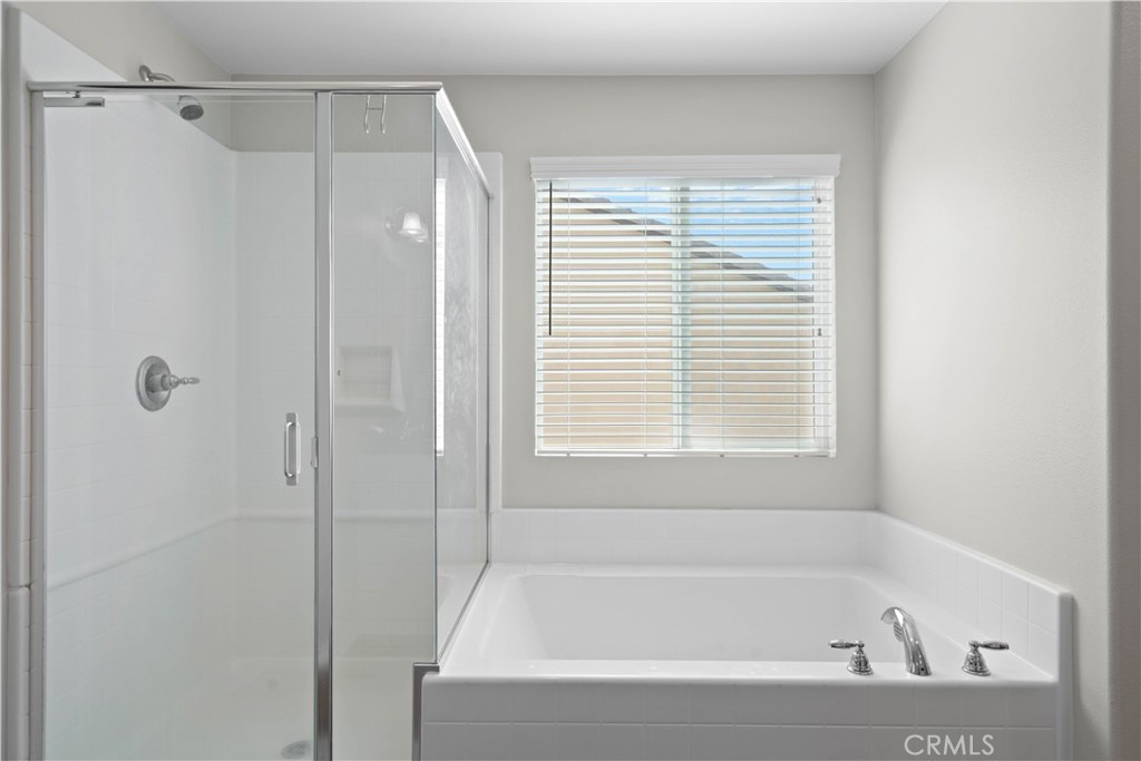 12875 Wainwright Lane Moreno Valley, CA 92555 - Photo 26 of 37 a bathroom with a bathtub and a shower