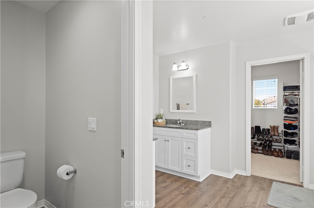 12875 Wainwright Lane Moreno Valley, CA 92555 - Photo 27 of 37 a bathroom with a granite countertop sink toilet and shower