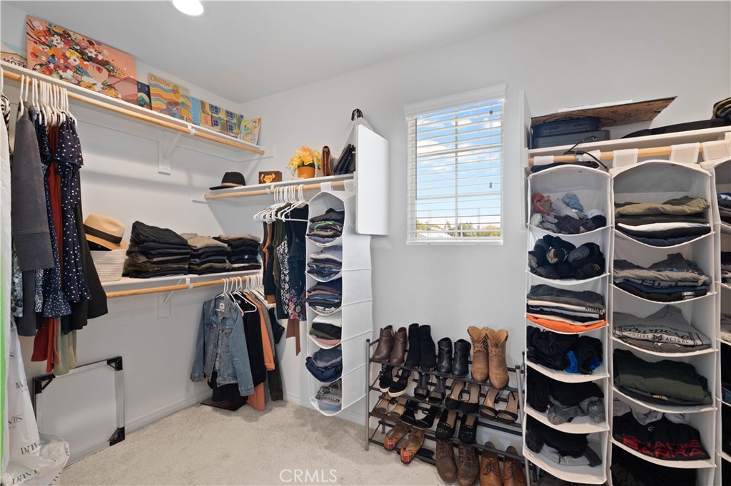 12875 Wainwright Lane Moreno Valley, CA 92555 - Photo 28 of 37 a view of walk in closet with clothes and shoes