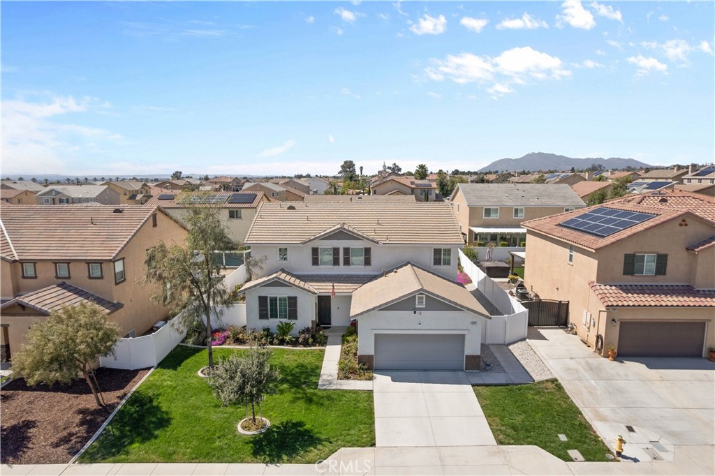 12875 Wainwright Lane Moreno Valley, CA 92555 - Photo 3 of 37 a front view of a house with a yard