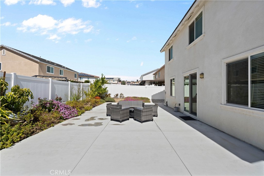 12875 Wainwright Lane Moreno Valley, CA 92555 - Photo 32 of 37 a roof deck with table and chairs and potted plants