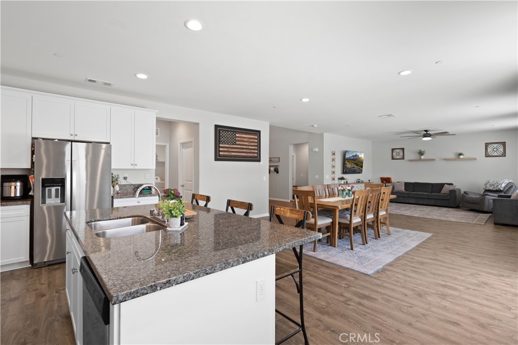 12875 Wainwright Lane Moreno Valley, CA 92555 - Photo 7 of 37 a kitchen with counter space dining table and stainless steel appliances