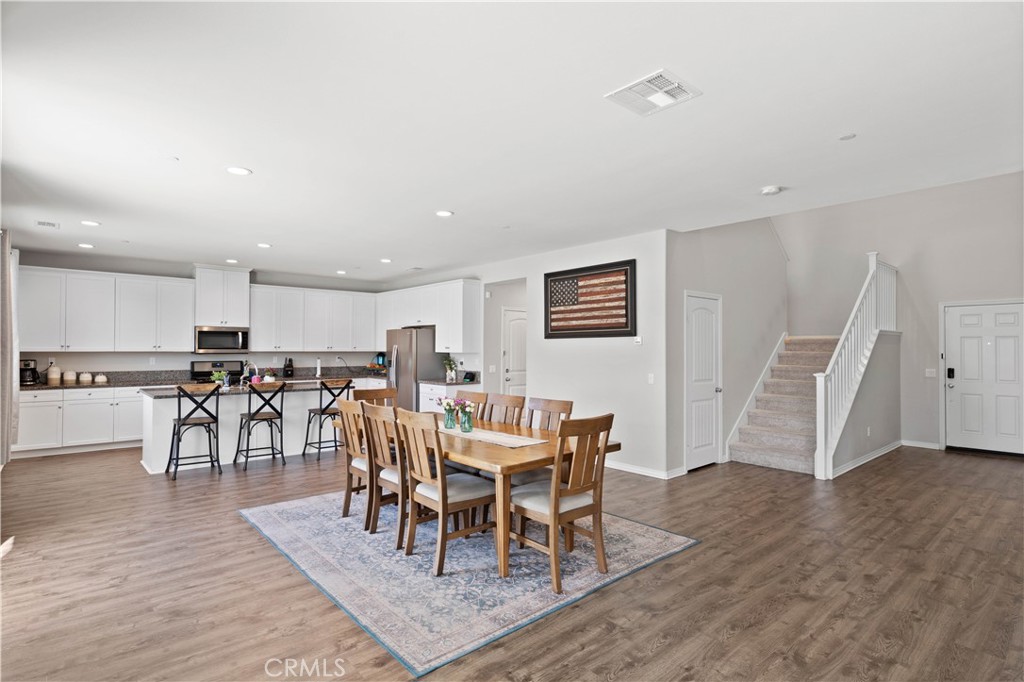 12875 Wainwright Lane Moreno Valley, CA 92555 - Photo 8 of 37 a view of a dining room with furniture and wooden floor