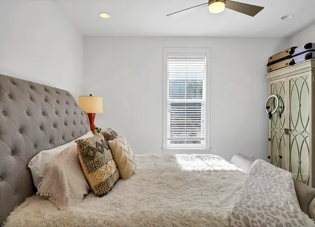 a bedroom with a bed and a window