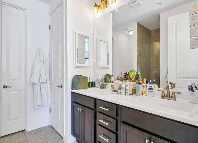 a bathroom with a double vanity sink and a mirror