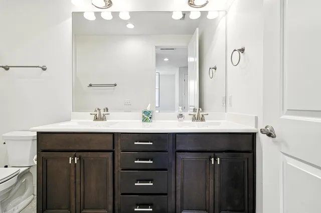 a bathroom with a sink double vanity and a mirror