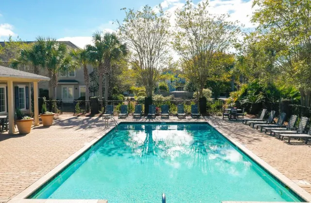 a view of a swimming pool with chairs