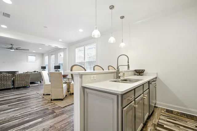 a kitchen with a sink cabinets and wooden floor