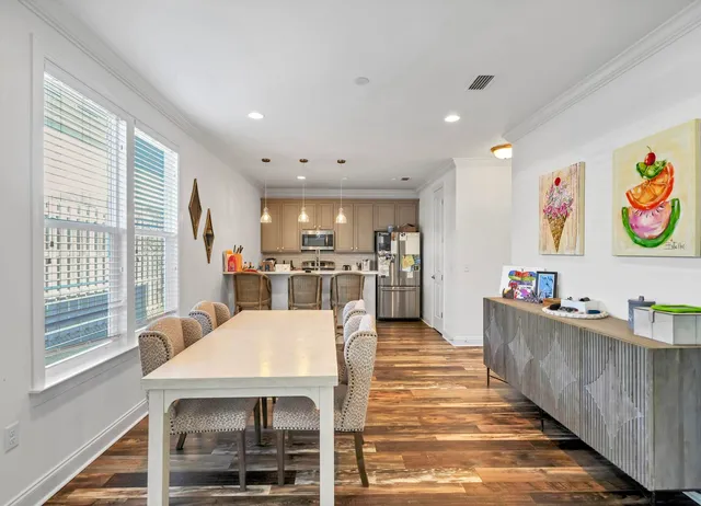 a view of kitchen with furniture and refrigerator