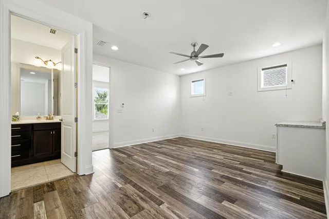 a view of an empty room with a kitchen