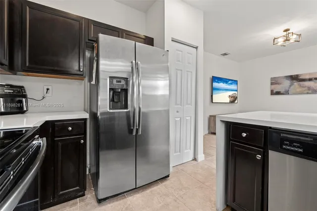 a kitchen with stainless steel appliances a refrigerator a stove a sink and dishwasher
