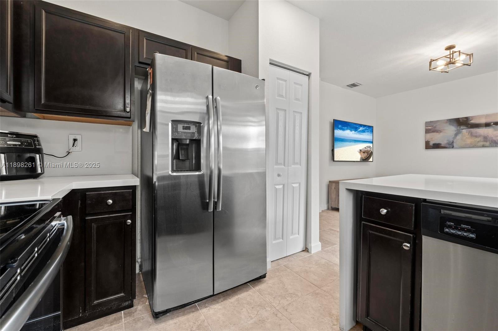 9000 Northwest 183rd Street, Unit 9000 Hialeah, FL 33018 - Photo 18 of 41 a kitchen with stainless steel appliances a refrigerator a stove a sink and dishwasher