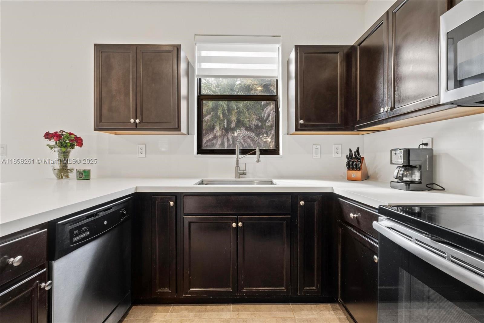 9000 Northwest 183rd Street, Unit 9000 Hialeah, FL 33018 - Photo 19 of 41 a kitchen with a sink and cabinets