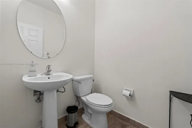 a bathroom with a sink a mirror and a toilet