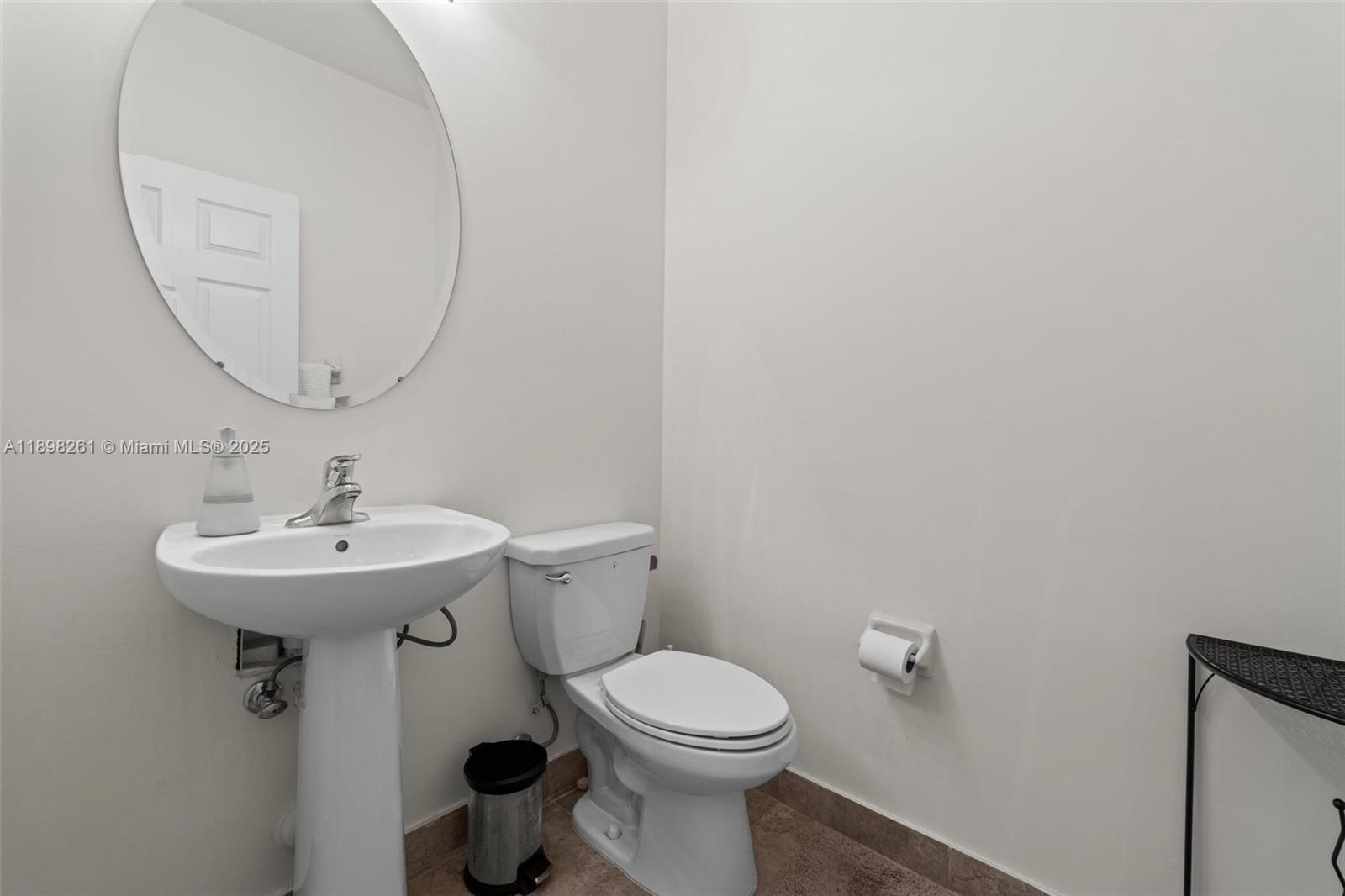 9000 Northwest 183rd Street, Unit 9000 Hialeah, FL 33018 - Photo 24 of 41 a bathroom with a sink a mirror and a toilet