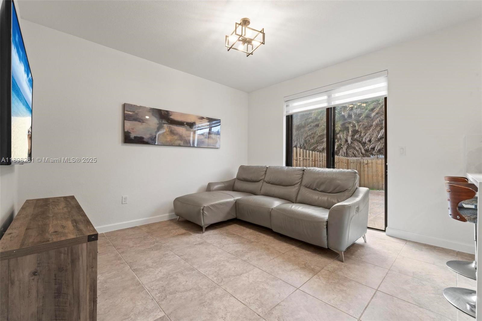 9000 Northwest 183rd Street, Unit 9000 Hialeah, FL 33018 - Photo 25 of 41 a living room with furniture and a window