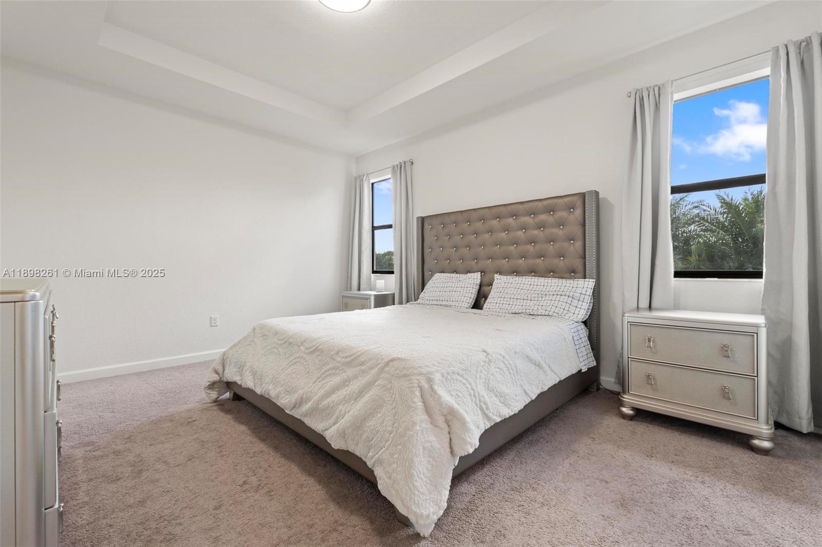 9000 Northwest 183rd Street, Unit 9000 Hialeah, FL 33018 - Photo 28 of 41 a bedroom with a bed and a window