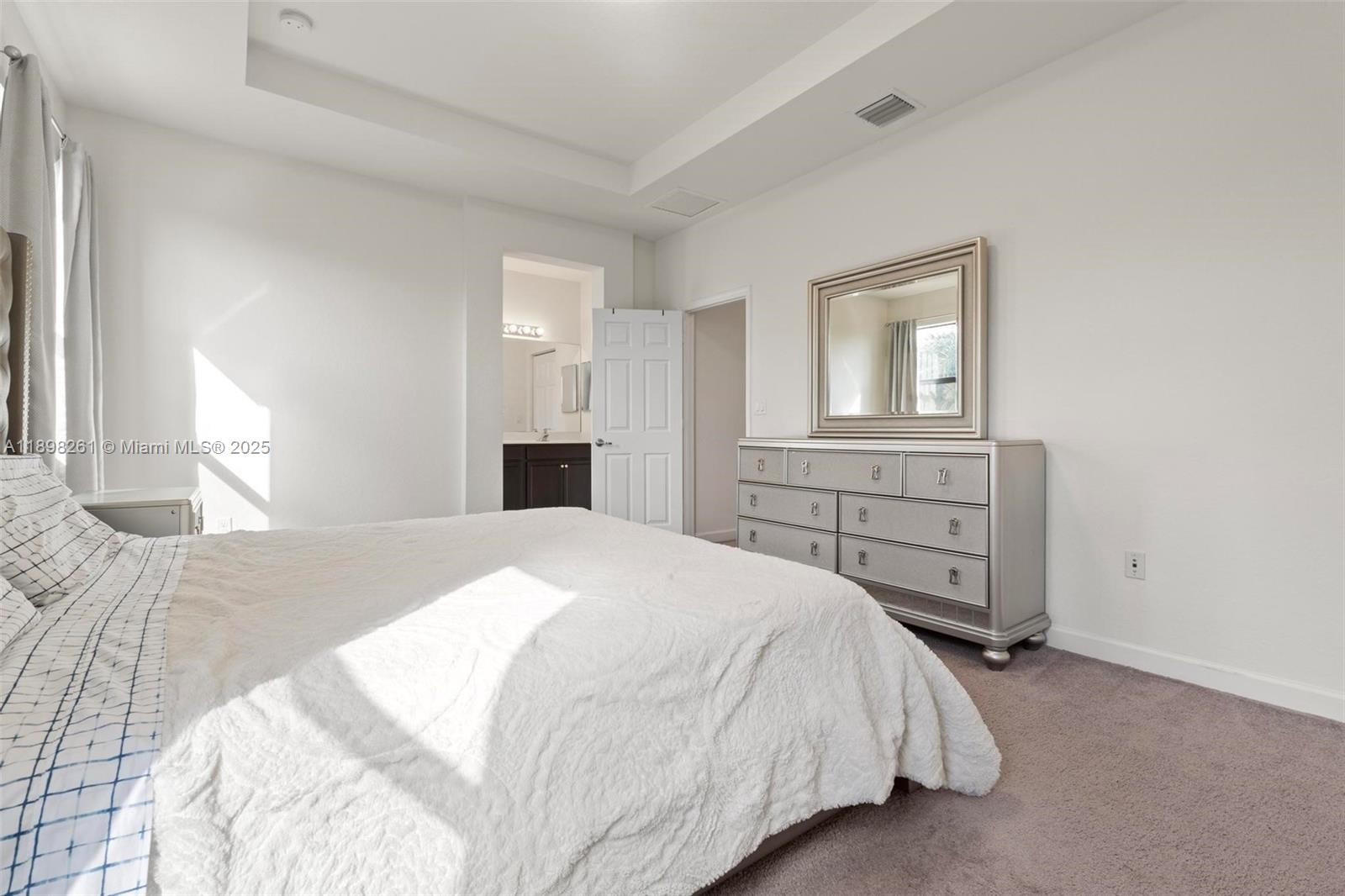 9000 Northwest 183rd Street, Unit 9000 Hialeah, FL 33018 - Photo 29 of 41 a spacious bedroom with a bed and dresser