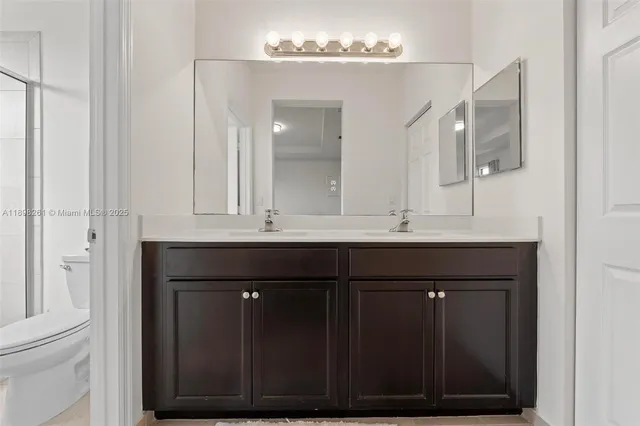 a bathroom with a sink vanity and a mirror