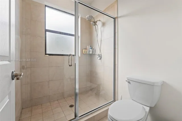 a bathroom with a shower and toilet