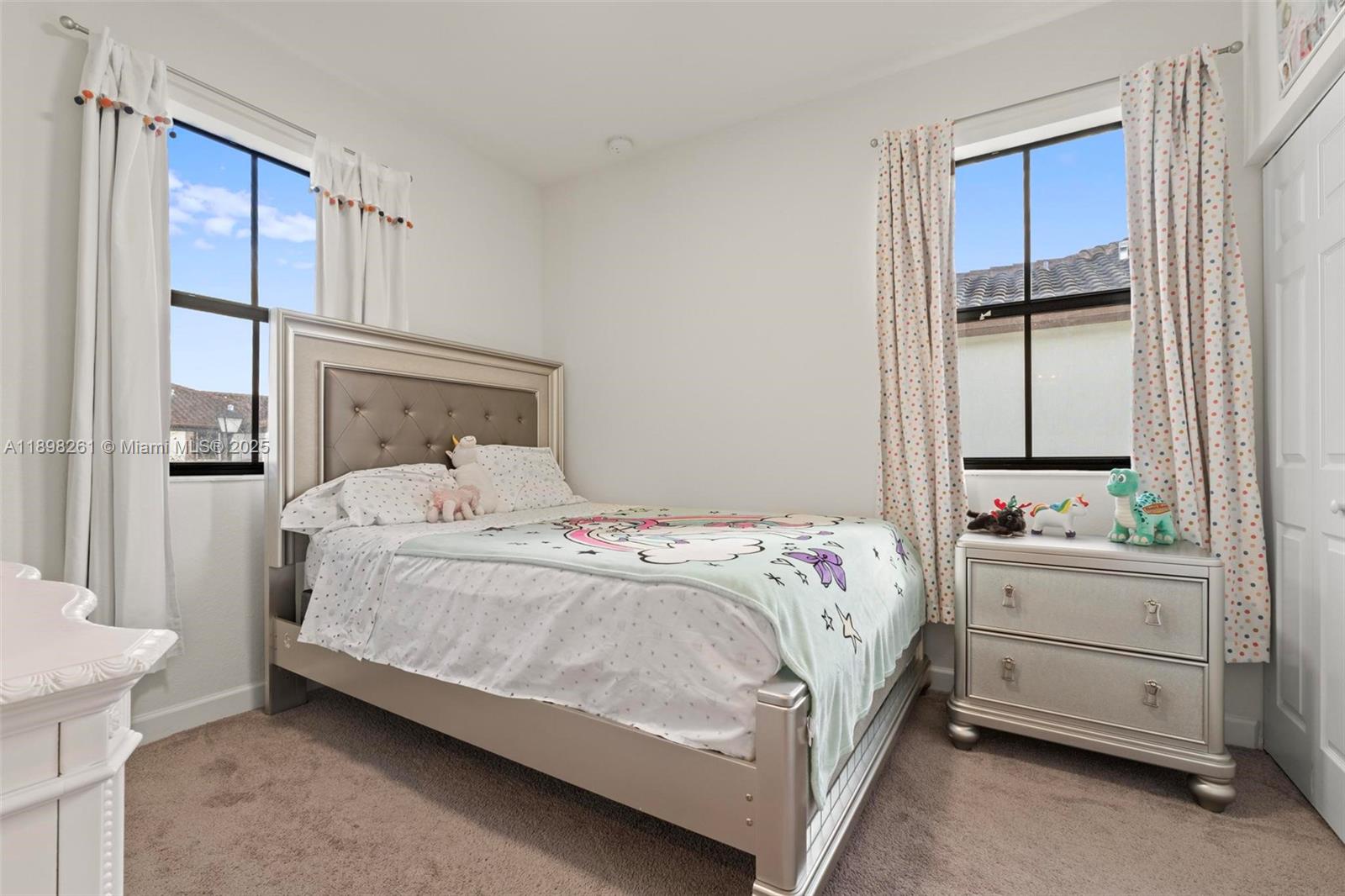 9000 Northwest 183rd Street, Unit 9000 Hialeah, FL 33018 - Photo 33 of 41 a bedroom with a bed and a window