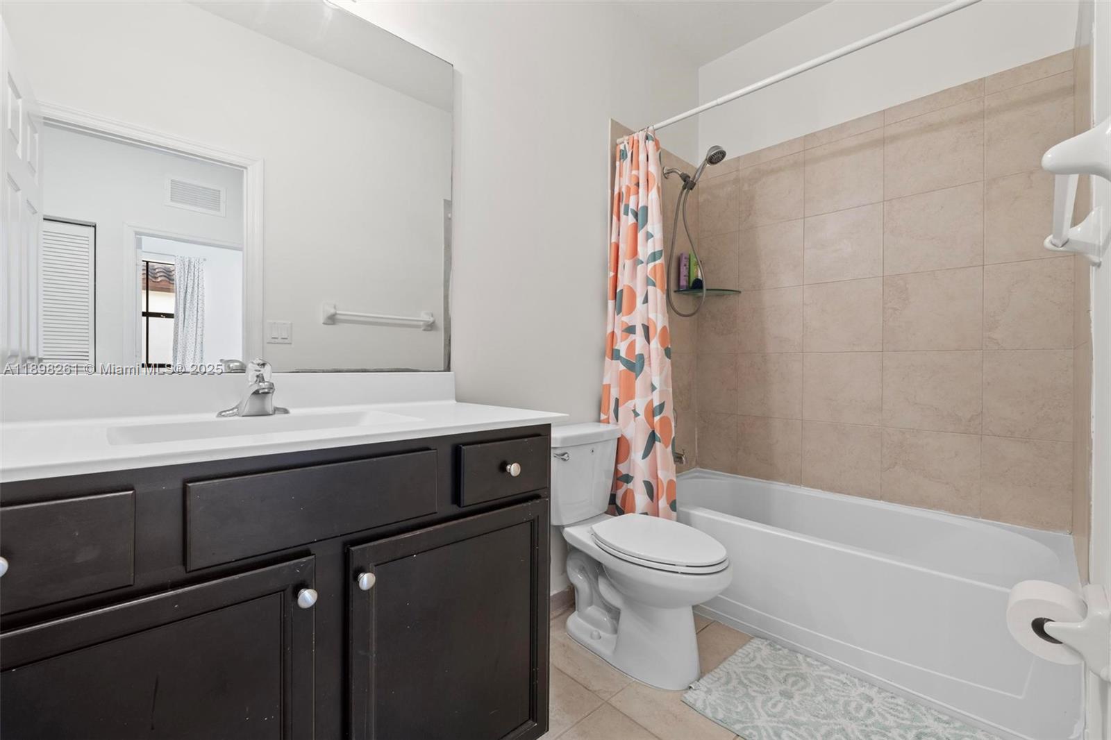 9000 Northwest 183rd Street, Unit 9000 Hialeah, FL 33018 - Photo 35 of 41 a bathroom with a sink a toilet and a bathtub