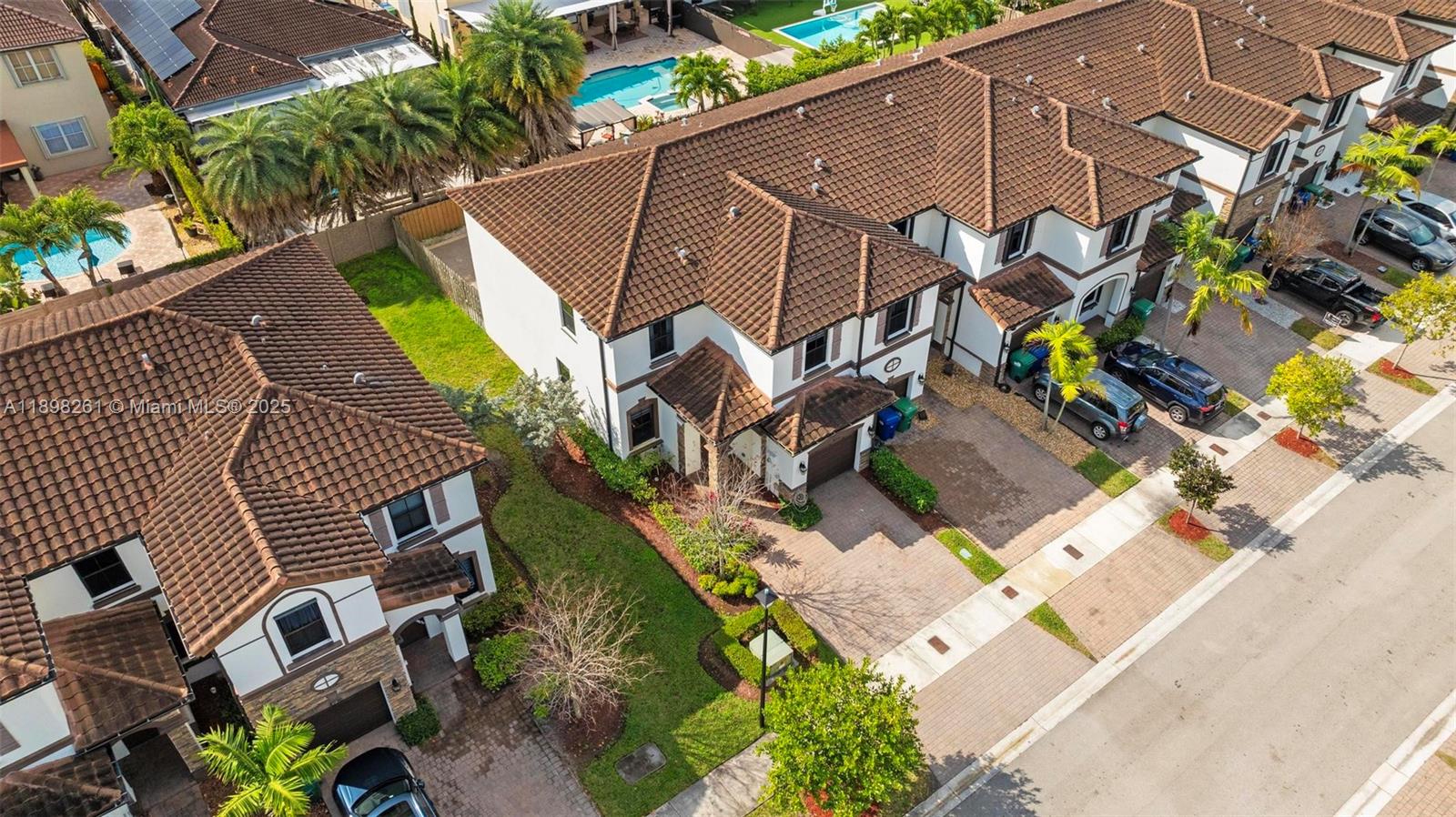 9000 Northwest 183rd Street, Unit 9000 Hialeah, FL 33018 - Photo 9 of 41 an aerial view of a house with a garden and parking space