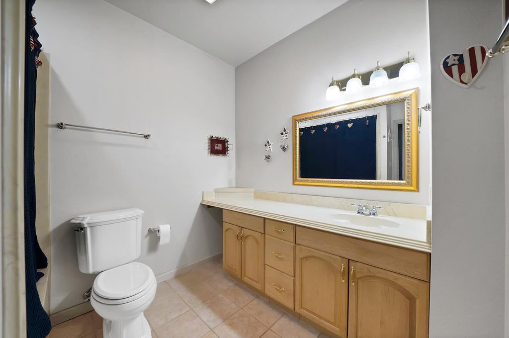 5010 Milam Road Mesquite, TX 75181 - Photo 16 of 40 Recessed ceiling lighting, full vanity with integrated sink, gold-framed mirror, and tiled flooring. Bath/shower combo.