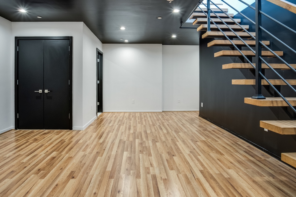 311 Hart Street, Unit 1A Brooklyn, NY 11206 - Photo 11 of 16 a bedroom with a bed and a black white checkered floor
