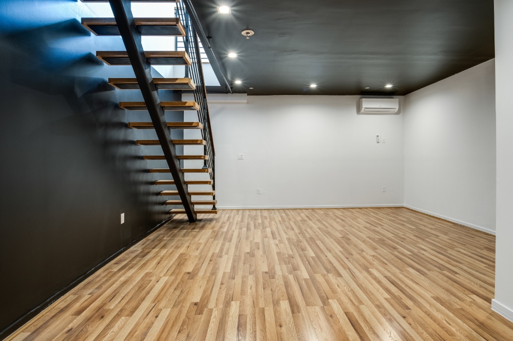311 Hart Street, Unit 1A Brooklyn, NY 11206 - Photo 12 of 16 wooden floor in an empty room with a window