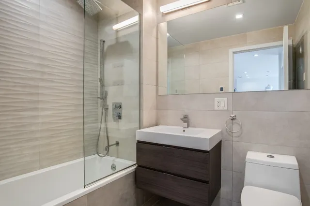 a bathroom with a sink toilet and shower