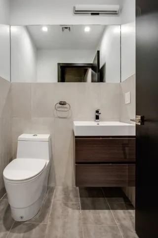a bathroom with a toilet sink and mirror
