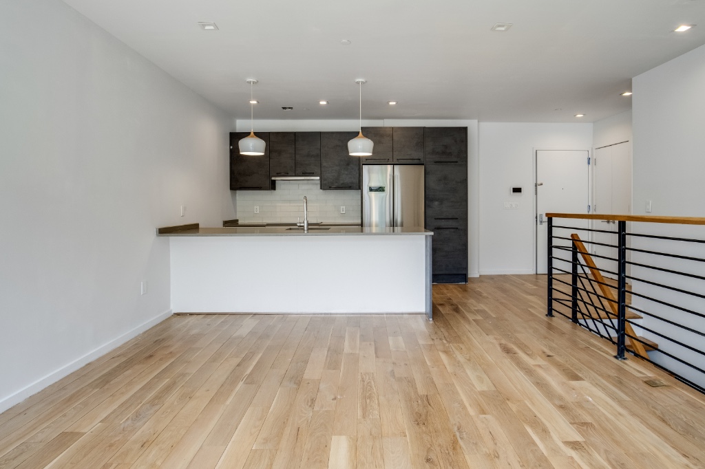 311 Hart Street, Unit 1A Brooklyn, NY 11206 - Photo 2 of 16 a view of a kitchen with wooden floor and electronic appliances
