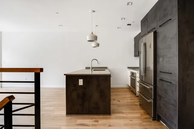 a hallway with a sink and a mirror