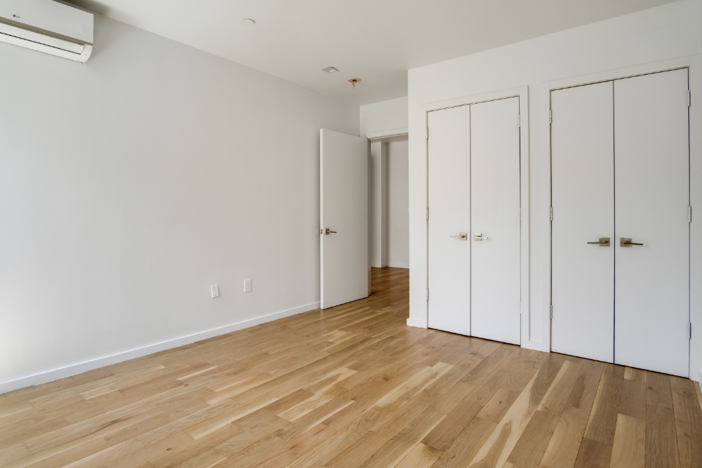 311 Hart Street, Unit 1A Brooklyn, NY 11206 - Photo 8 of 16 a view of an empty room with wooden floor