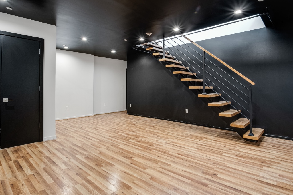 311 Hart Street, Unit 1A Brooklyn, NY 11206 - Photo 10 of 16 a view of an empty room with stairs and ventilation