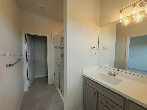 a bathroom with a glass shower door