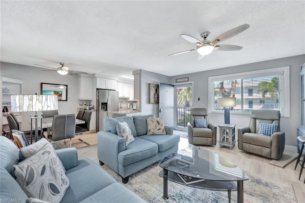 766 Central Avenue, Unit 207 Naples, FL 34102 - Photo 2 of 18 a living room with furniture and a large window