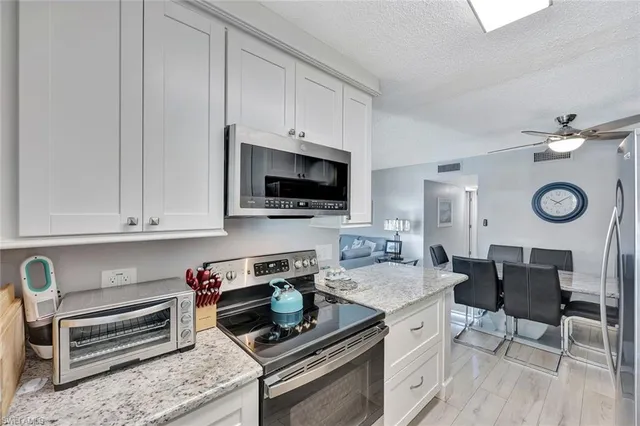 a view of a patio with couches table and chairs and potted plants