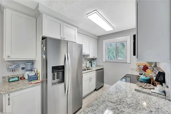 a kitchen with a refrigerator and a sink