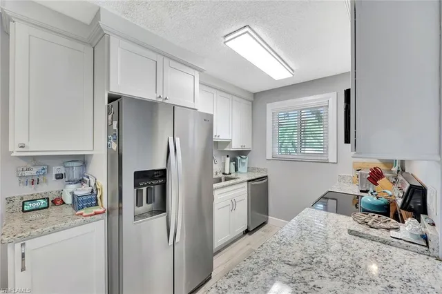 a kitchen with a refrigerator and a sink