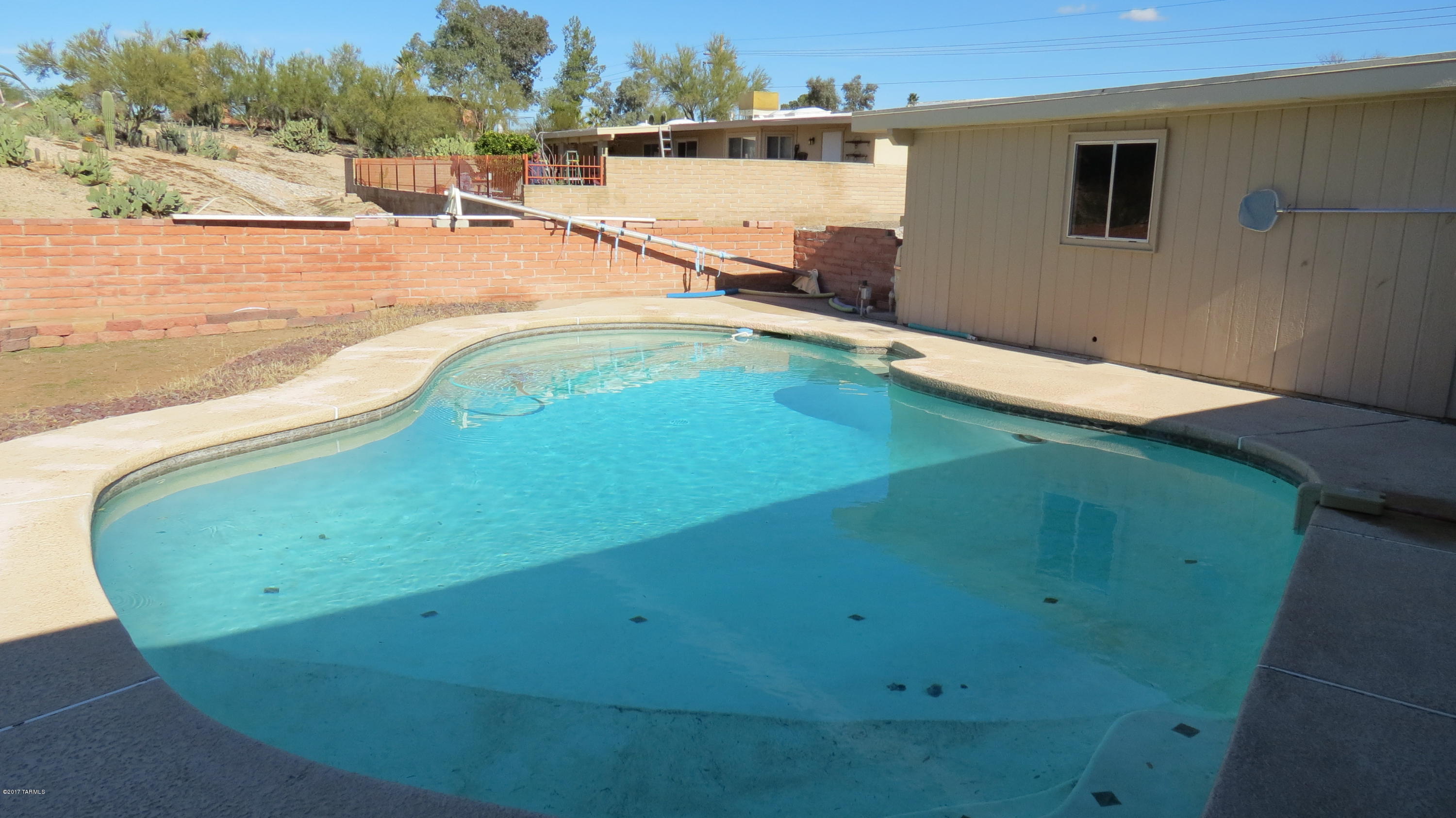 6601 North Mona Lisa Road Tucson, AZ 85741 - Photo 16 of 23 a view of a swimming pool with an outdoor space