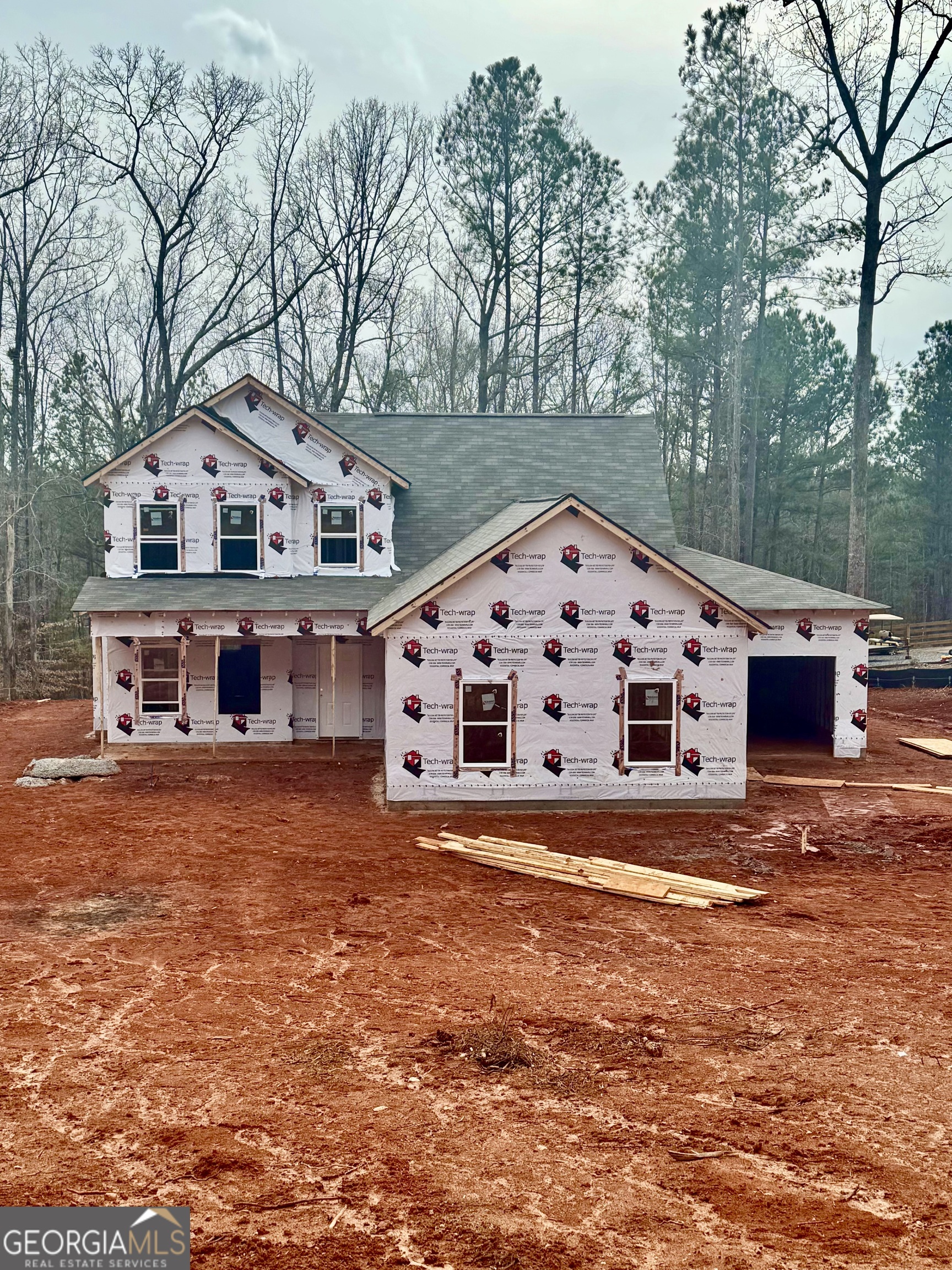 a large house with a big yard and large trees